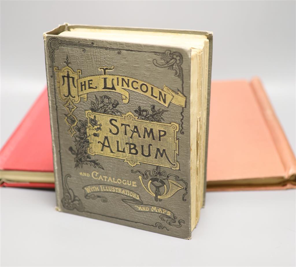 A Stanley Gibbons red stamp album and two others, each mounted with an accumulation of all world postage stamps